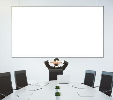 stock-photo-businessman-looks-at-blank-poster-on-the-wall-in-modern-conference-room-mock-up-376609825